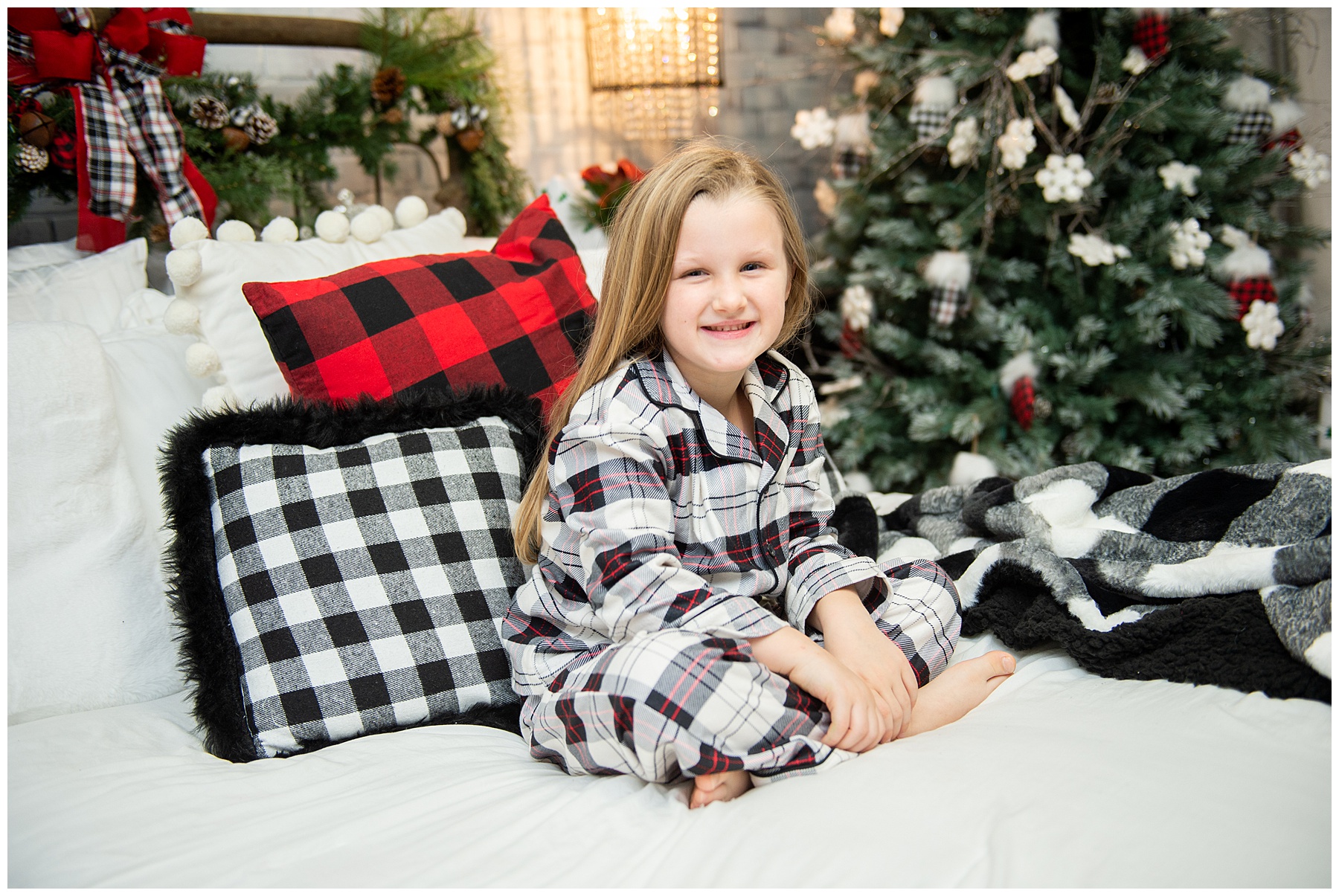 young girl smiling at camera and posing during family holiday pictures in Knoxville TN
