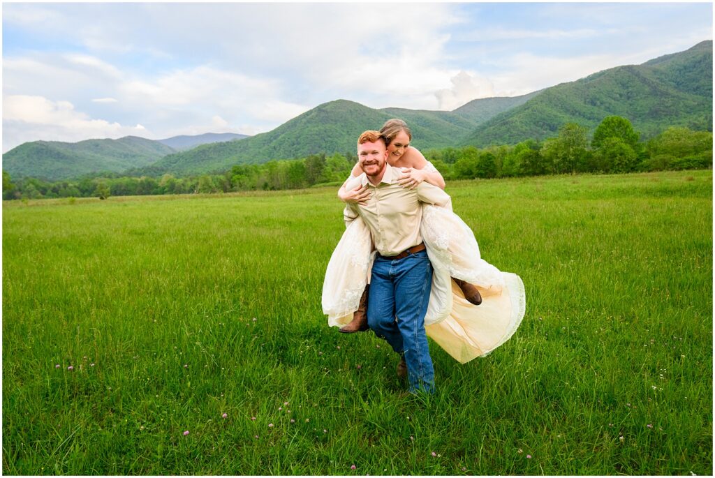 bride and groom running through field in Cades Cove in great smoky mountains national park